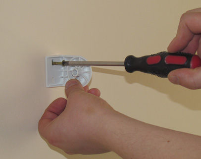 Przewiercamy wiertarką ( sugerowane wiertło to 8 mm ) otwór na kołek rozporowy a następnie mocujemy do ściany jeden z mocowań rolety